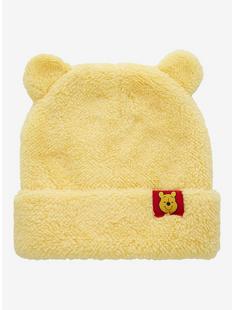 A yellow hat with a bear patch

Description automatically generated