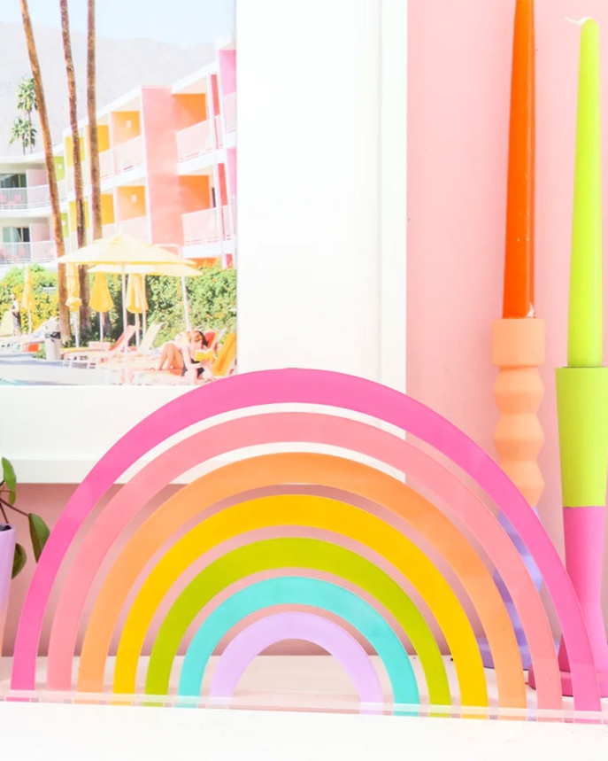 A rainbow sculpture in front of a window

Description automatically generated