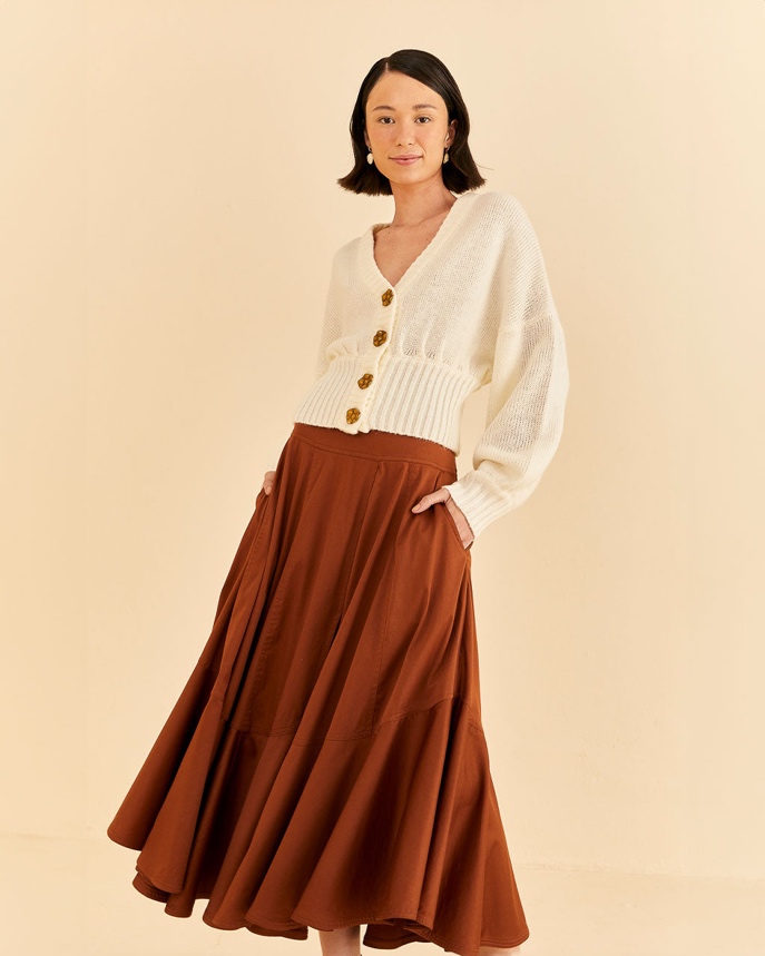A person in a long brown skirt

Description automatically generated